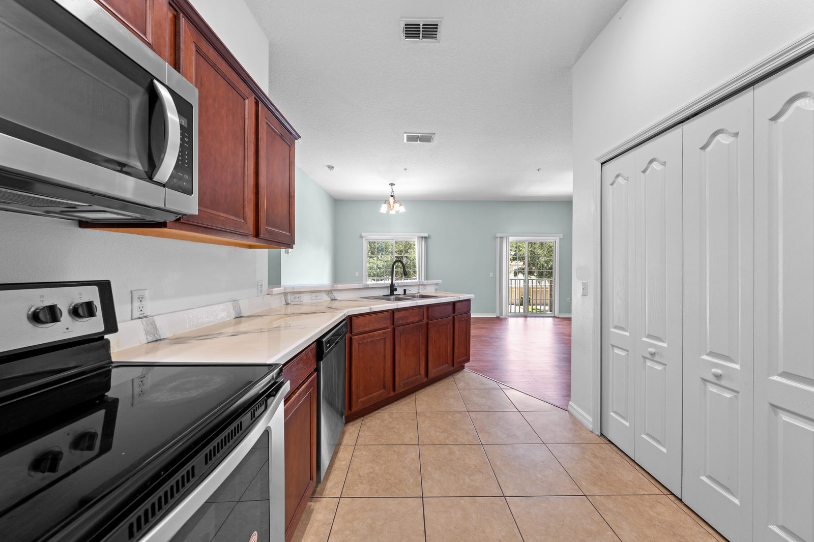 Kitchen with wood cabinets, granite counters, and stainless appliances