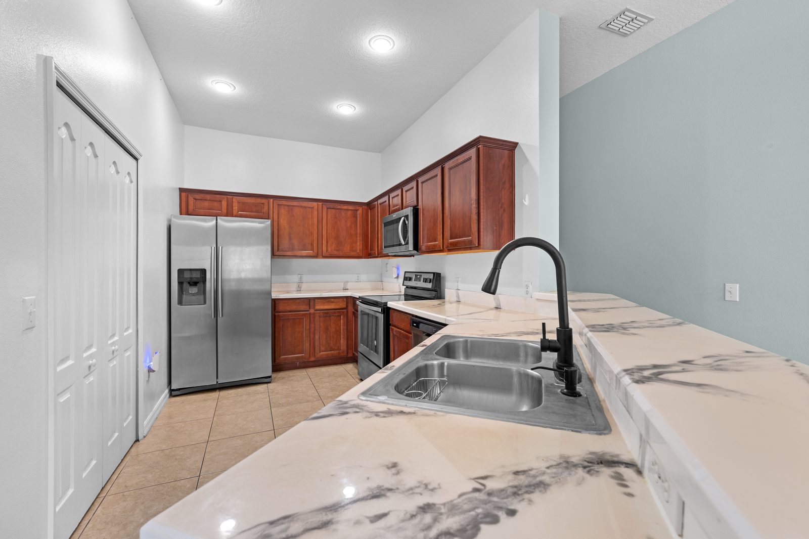 Kitchen sink and counter with view into the living area