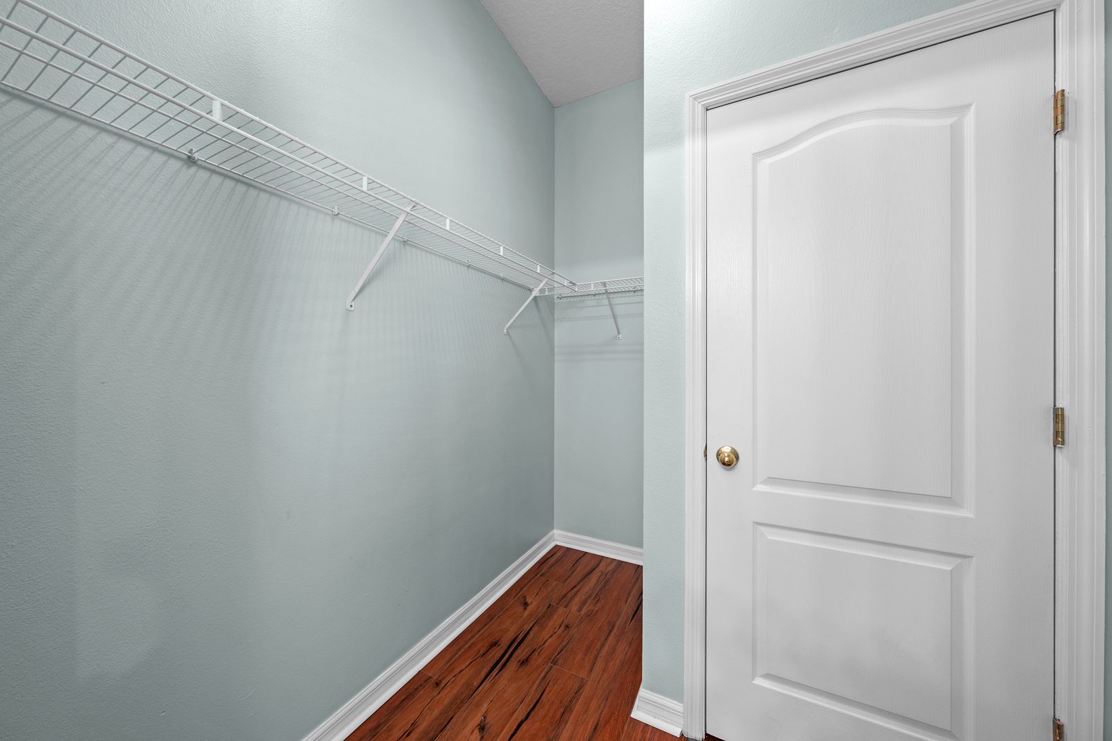 Primary bedroom walk-in closet