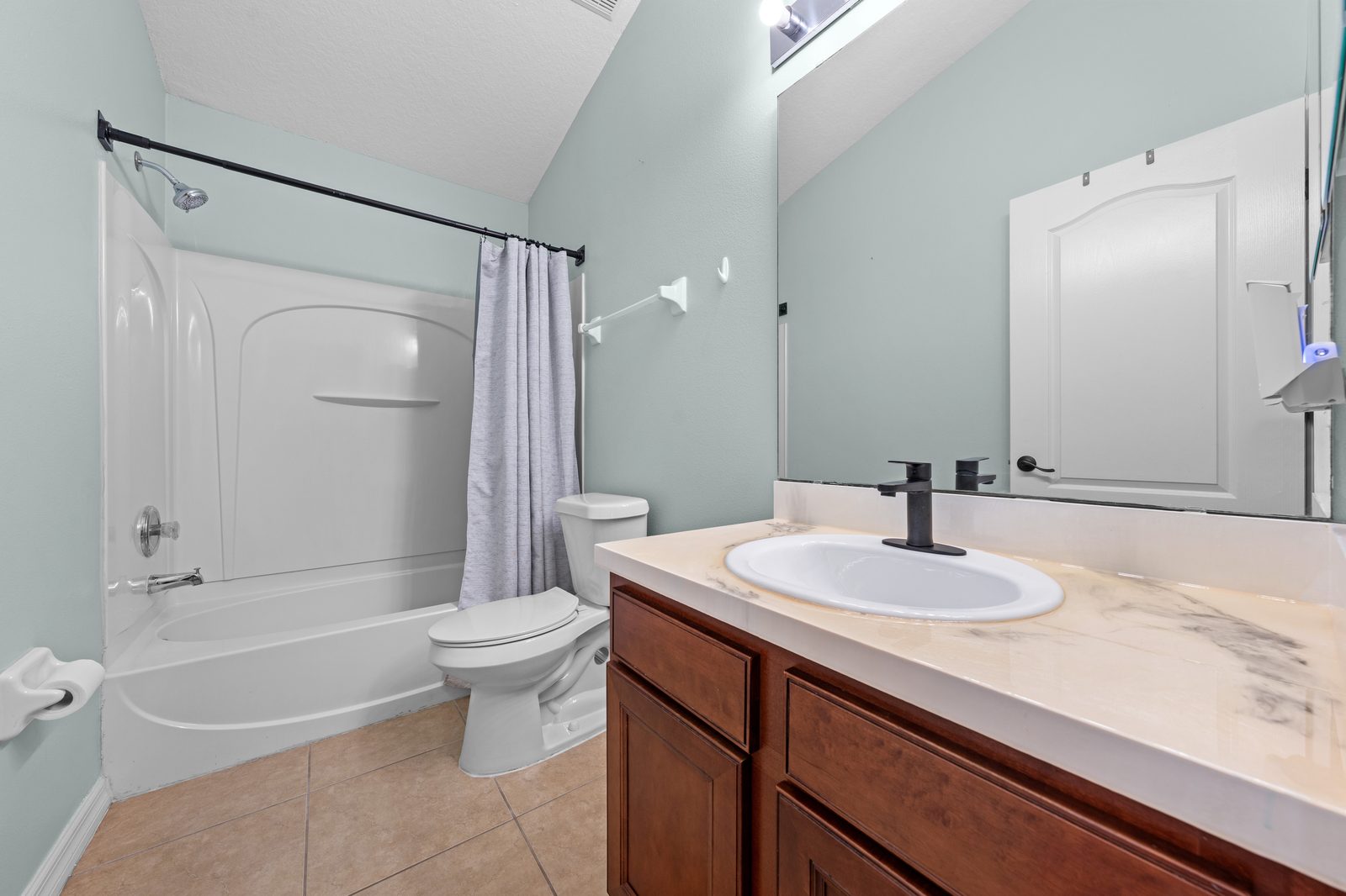Hall bathroom with tub and shower combo