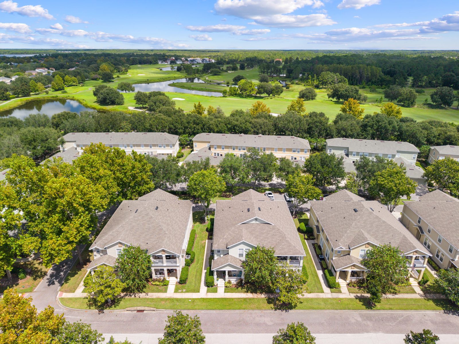 Aerial view of the Harmony community with golf course and pond
