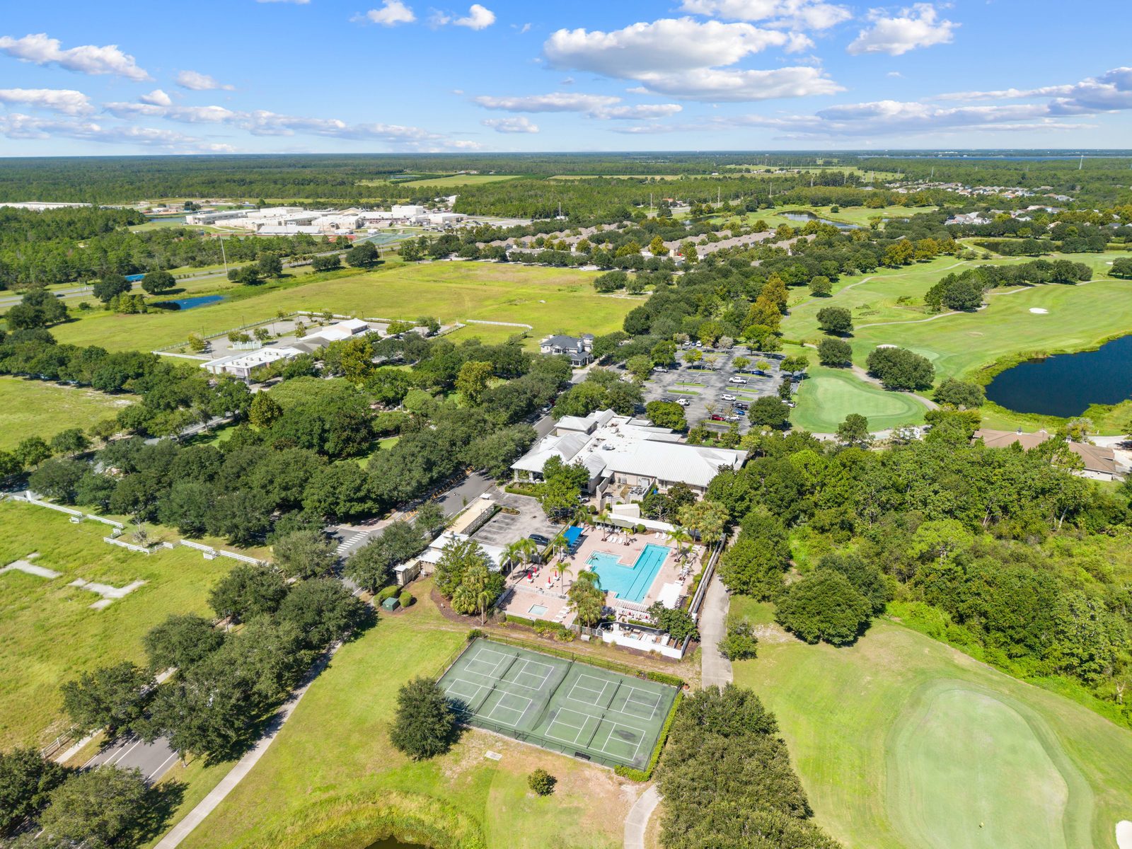 Aerial view of the golf course, tennis courts, and community pool